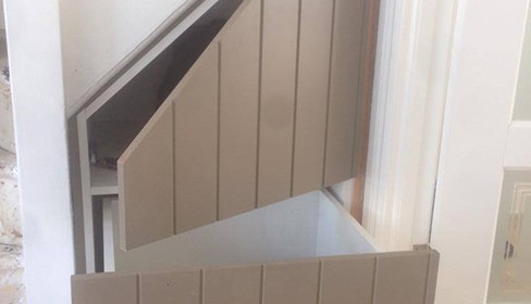 Hallway with pull out under-stair storage