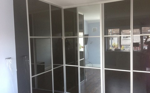 Custom built high gloss wardrobe with sliding doors