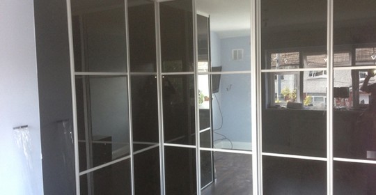 Custom built high gloss wardrobe with sliding doors